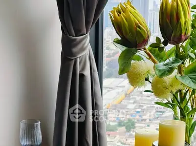 Elegant interior with city view, featuring stylish curtains and decorative plants.