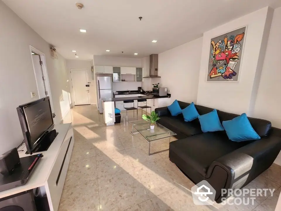 Spacious open-plan living area with modern furnishings, sleek kitchen appliances, and ample natural light, perfect for entertaining and relaxation.