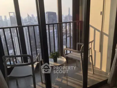 Stunning city view from a modern balcony with stylish seating, perfect for relaxation and enjoying the skyline.
