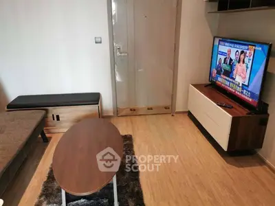 Modern living room with sleek furniture and flat-screen TV, perfect for cozy relaxation.