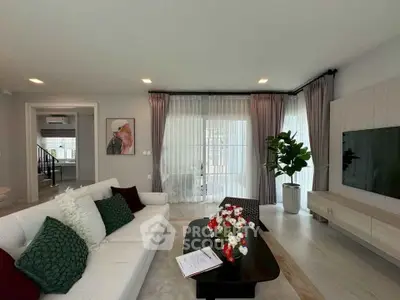 Spacious modern living room with elegant decor and large windows