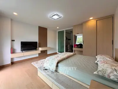 Spacious modern bedroom with stylish decor and natural light