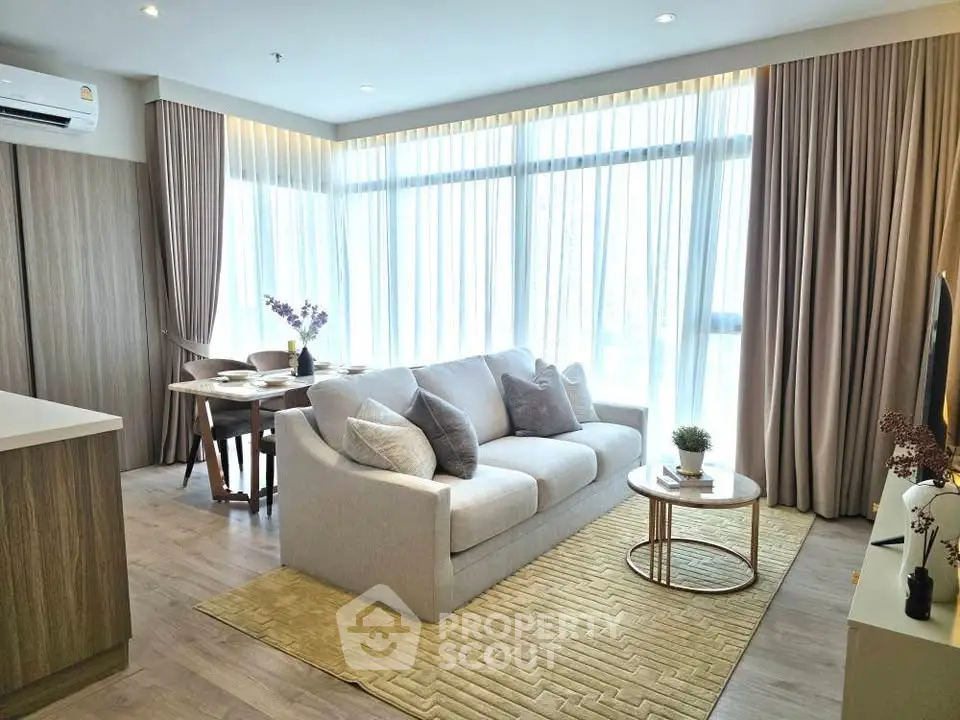 Modern living room with elegant decor and natural light in a stylish apartment.