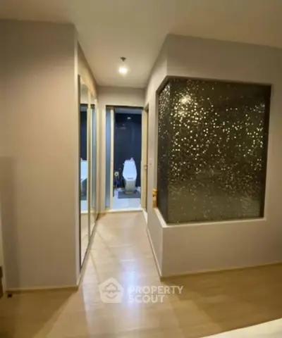 Modern apartment hallway with stylish bathroom and mirrored closet doors