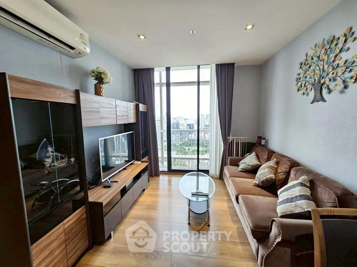 Modern living room with city view, stylish decor, and cozy seating area.