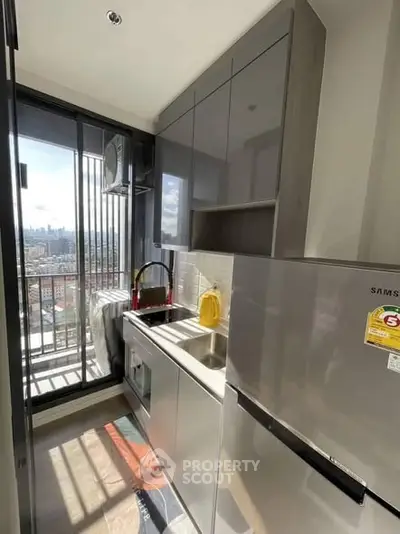 Modern kitchen with sleek appliances and city view from balcony