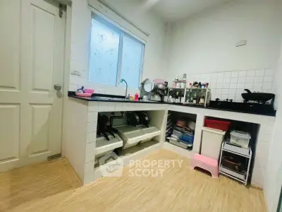 Charming kitchen with open layout and gas stove, featuring modern design and efficient use of space.