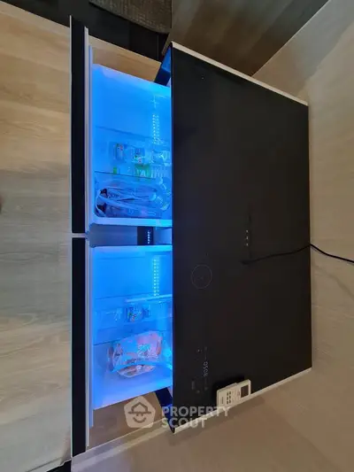 Modern kitchen with sleek built-in refrigerator drawers and ambient lighting