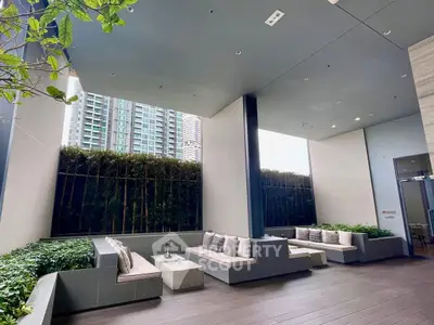 Luxurious modern outdoor seating area with city view and lush greenery