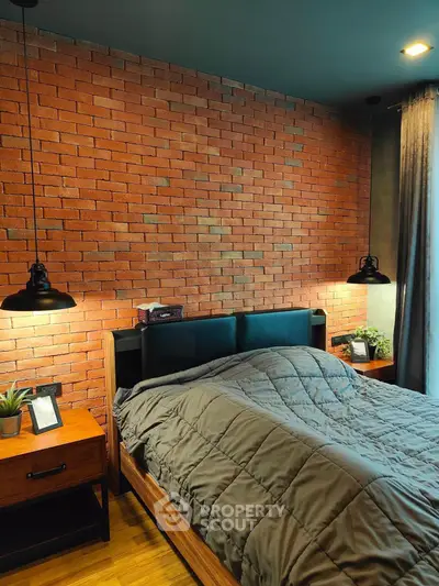 Modern bedroom with exposed brick wall and stylish lighting