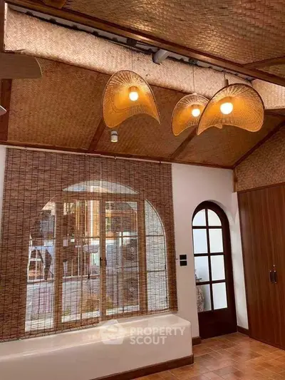 Charming interior with woven ceiling and unique lighting in a cozy living space.