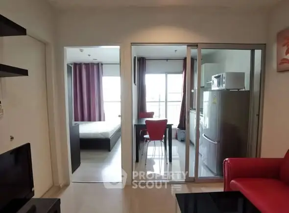 Modern apartment interior with open layout, featuring a cozy living area and kitchen with dining space.