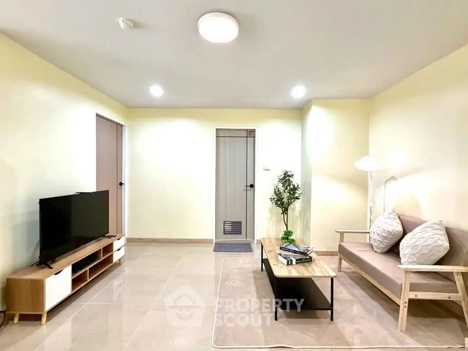 Modern living room with sleek furniture and neutral tones, perfect for relaxation and entertainment.