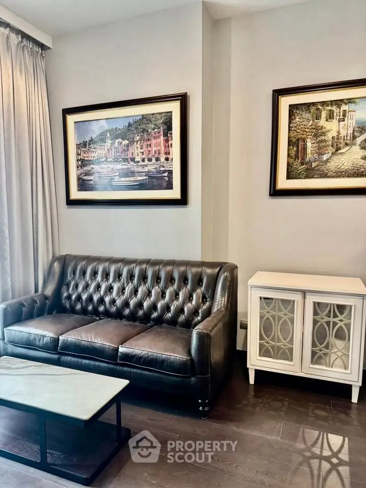 Elegant living room with leather sofa and framed art, perfect for modern comfort.