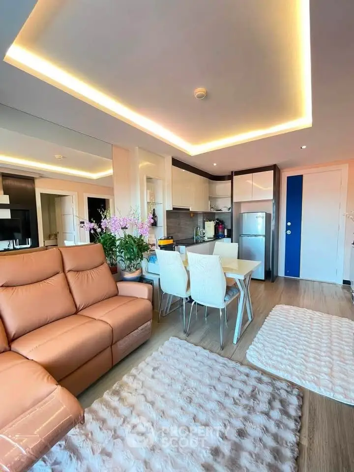 Modern open-layout living room with cozy seating and stylish kitchen