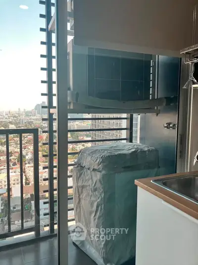 Modern apartment balcony with city view and covered washing machine