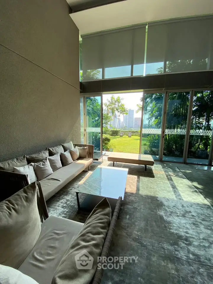 Luxurious living room with floor-to-ceiling windows and garden view