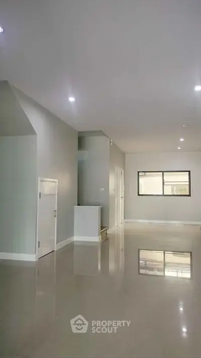 Spacious modern interior with sleek flooring and ample natural light, perfect for customization.