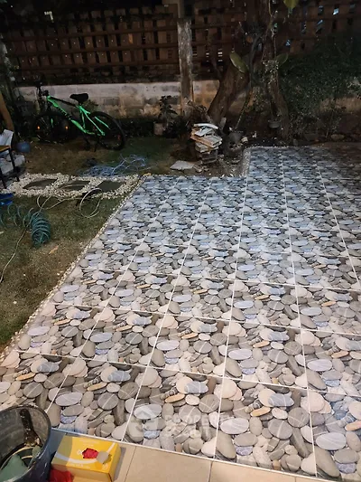 Charming garden with newly tiled patio and lush greenery