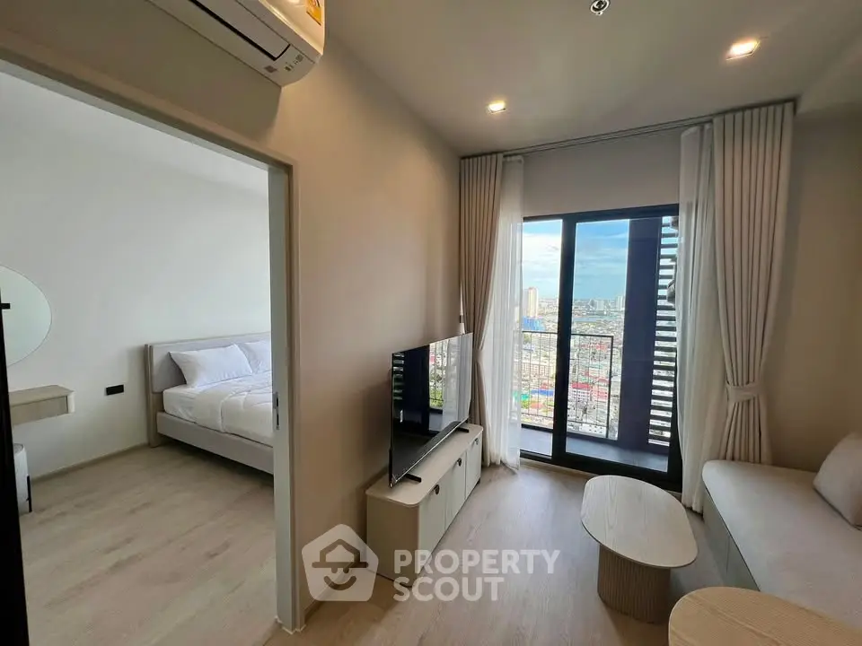 Modern apartment living room with city view, featuring sleek furniture and natural light.
