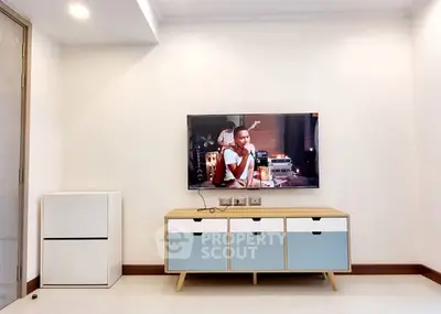 Modern living room with sleek TV setup and stylish storage unit.
