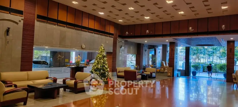 Luxurious building lobby with festive decor and elegant seating area