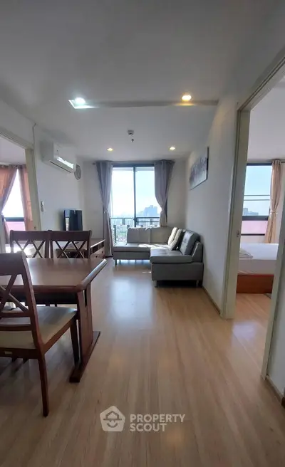 Spacious living room with dining area and city view in modern apartment