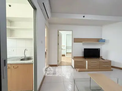 Modern living room with sleek furniture and open kitchen view