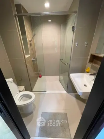 Modern bathroom with glass shower and sleek fixtures