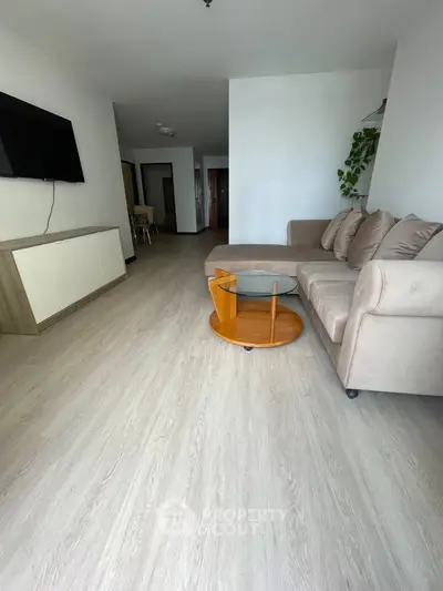 Spacious living room with modern decor and sleek wooden flooring