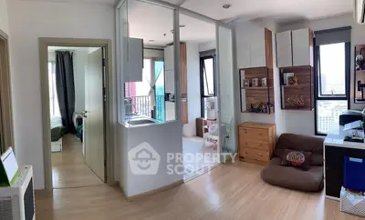 Modern apartment interior with open layout, featuring a cozy living area and a glimpse of the bedroom.