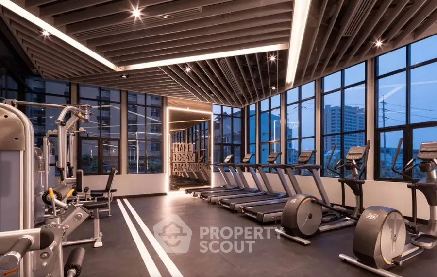 Modern gym with state-of-the-art equipment and panoramic city views, perfect for fitness enthusiasts.
