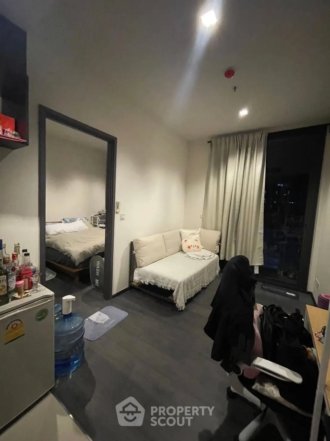 Cozy studio apartment with modern decor and natural lighting, featuring a compact living area and bedroom.