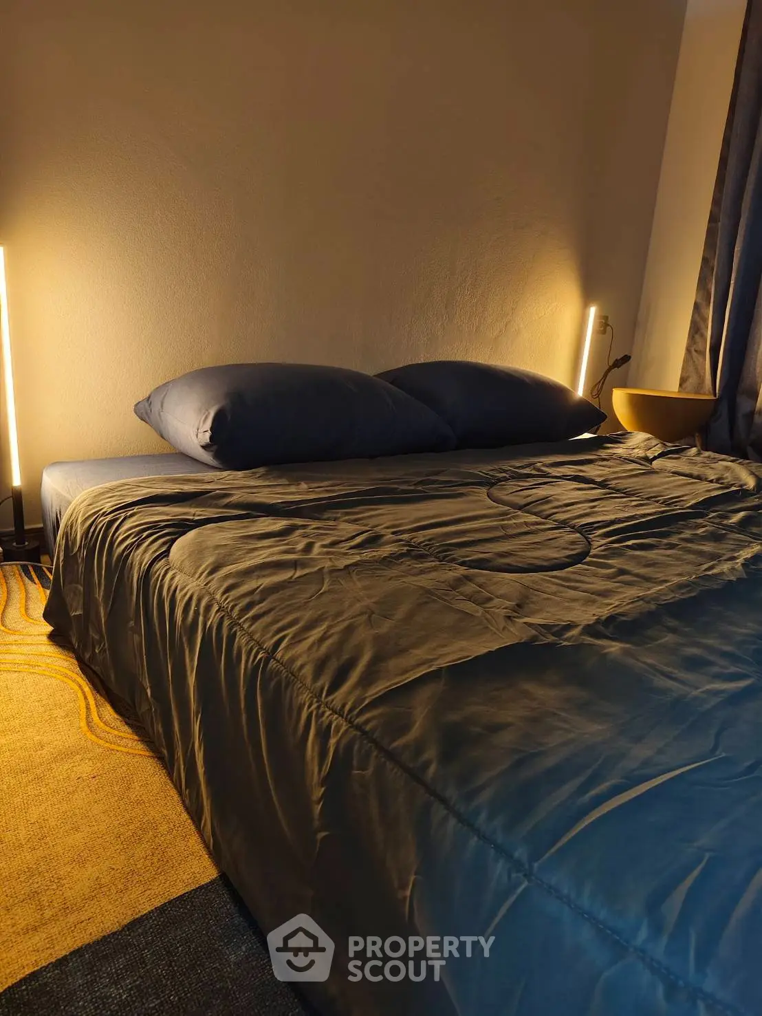 Cozy bedroom with modern lighting and stylish bedding
