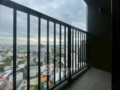 Stunning cityscape view from high-rise balcony with sleek railing design.