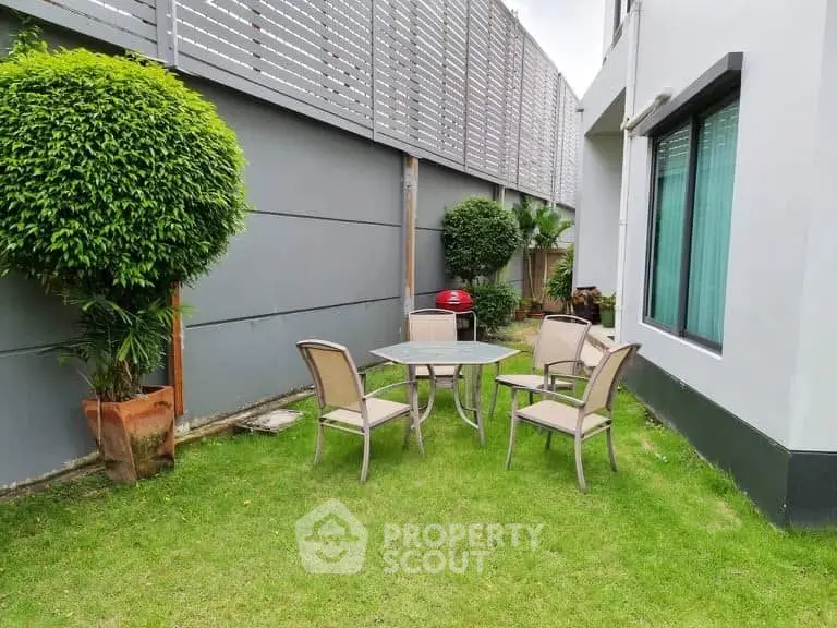 Charming garden area with outdoor seating in modern residential property