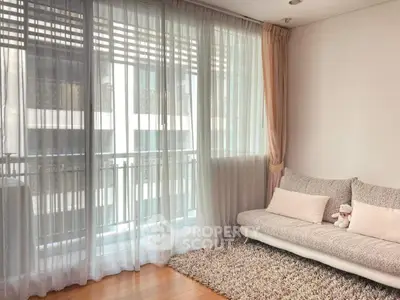 Bright living room with large windows and cozy sofa in modern apartment