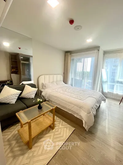 Modern studio apartment with cozy bed and stylish decor