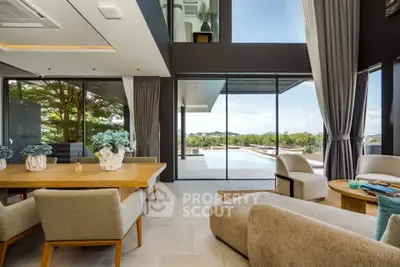 Luxurious open-plan living room with pool view and elegant decor