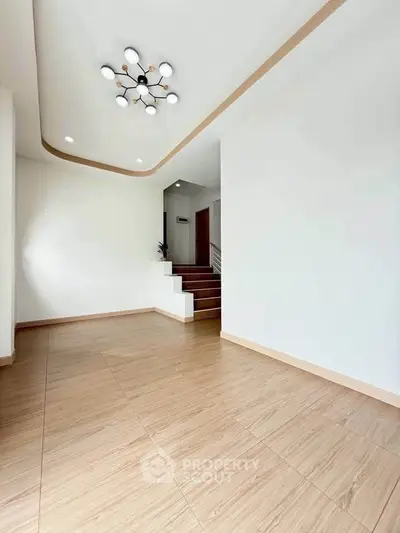 Spacious modern interior with elegant lighting and wooden flooring