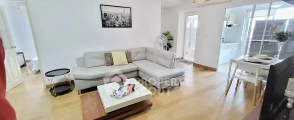 Spacious modern living room with stylish decor and open dining area, perfect for comfortable living.