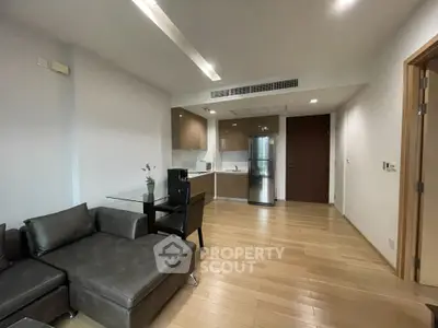 Modern open-plan living room with sleek kitchen and stylish furniture