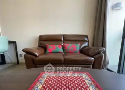 Cozy living room with brown leather sofa and vibrant cushions, perfect for relaxation.