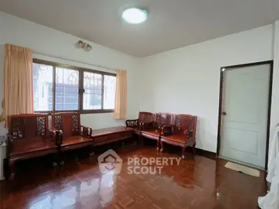 Spacious living room with elegant wooden furniture and large window