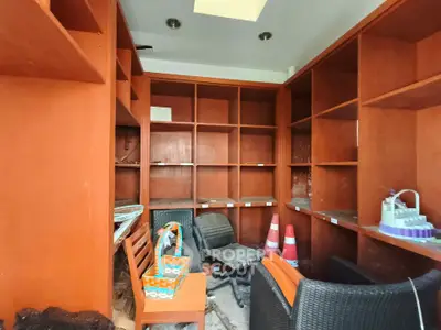 Spacious study room with built-in wooden shelves and modern seating