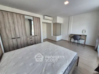 Spacious bedroom with modern furniture and natural light