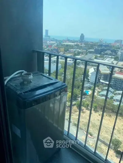 High-rise balcony with washing machine and stunning cityscape view