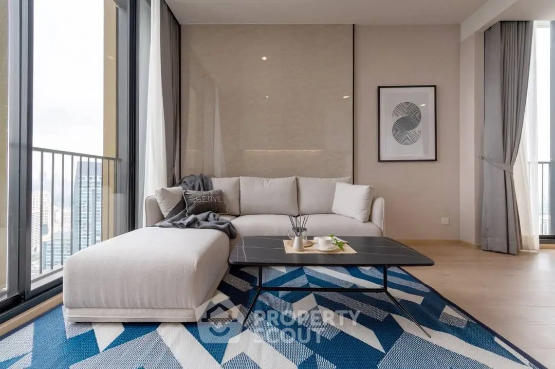 Modern living room with stylish sofa, geometric rug, and city view balcony.