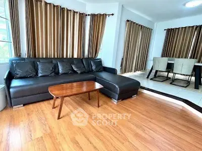 Spacious living room with elegant wooden flooring and modern furniture