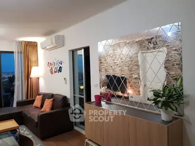 Modern living room with stylish decor, large window, and cozy seating area in a contemporary apartment.